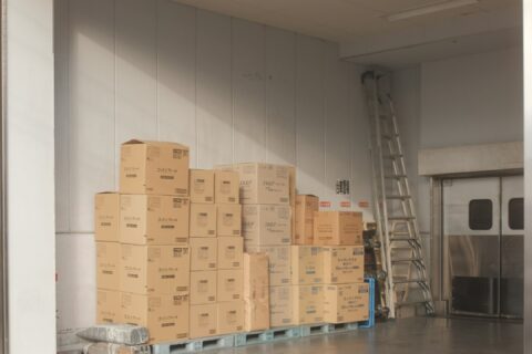 brown cardboard boxes on white floor tiles