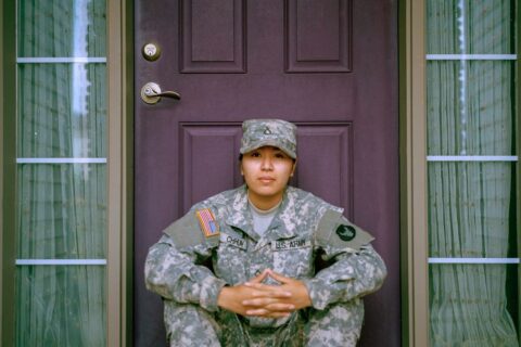 woman sitting in front of closed door