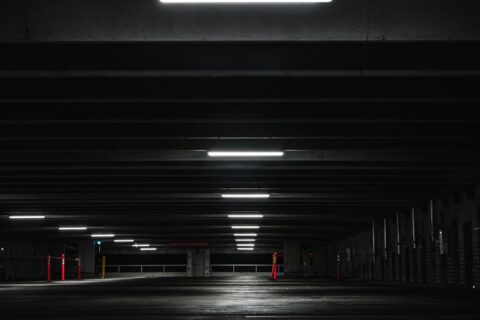 an empty parking garage at night with lights on