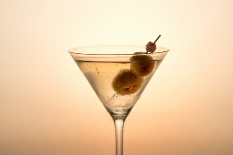 clear cocktail glass with yellow liquid