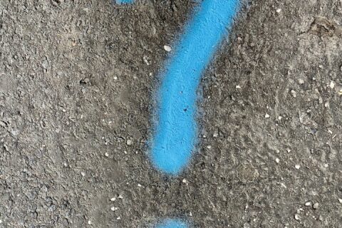 a blue question mark painted on the ground