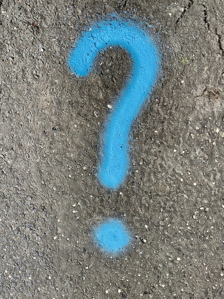 a blue question mark painted on the ground