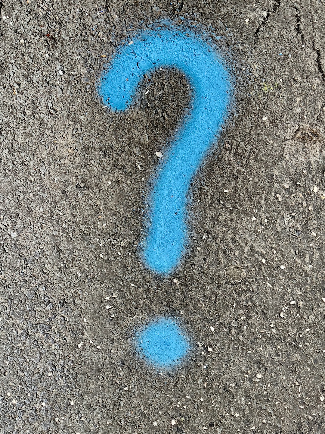 a blue question mark painted on the ground