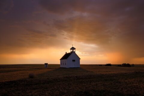 a house with a sunset in the background