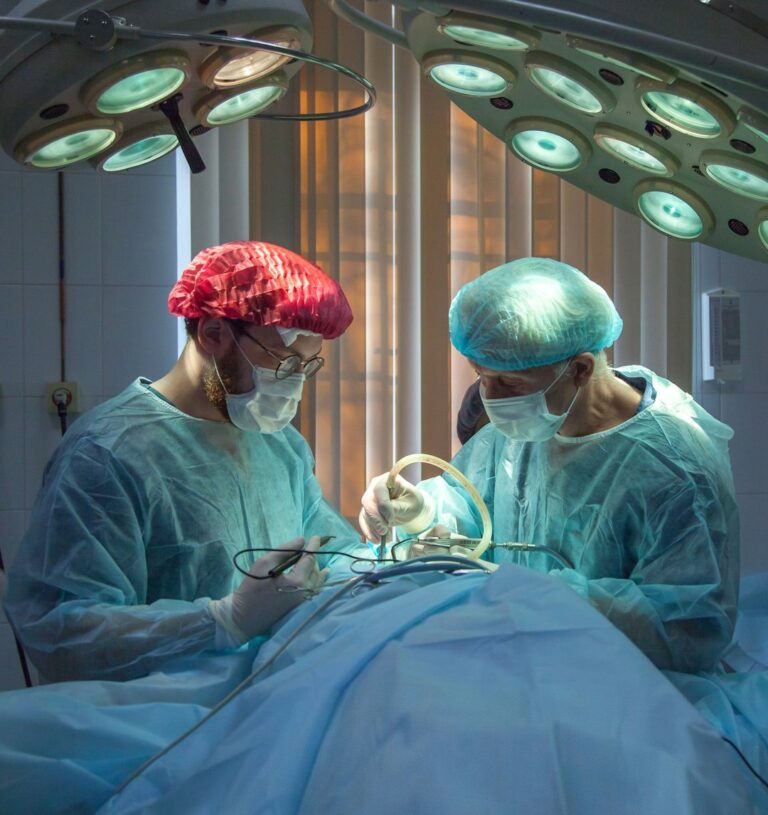 two men wearing blue lab coats