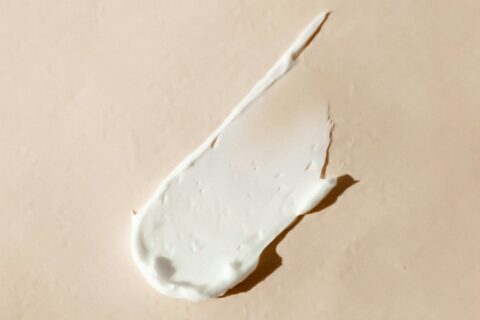 white cream smear on beige surface
