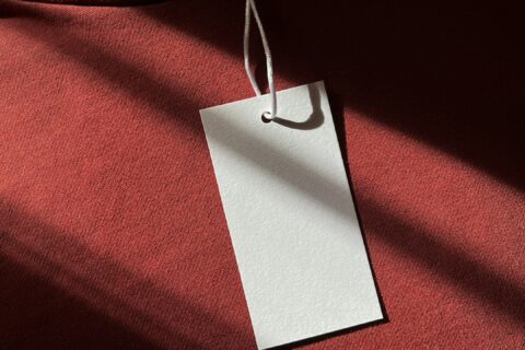 a red cloth with a white tag hanging from it
