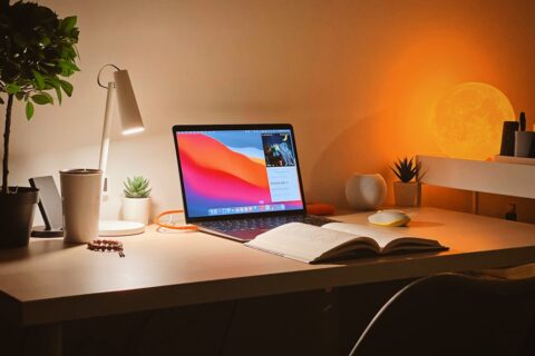macbook pro on white wooden desk