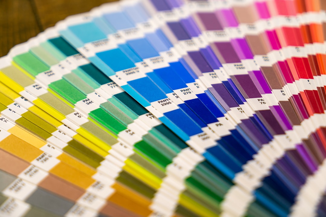 A fan deck of colorful paper swatches arranged in a spectrum on a surface