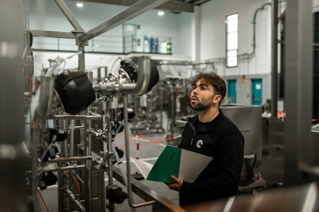 A man inspects machinery in a factory