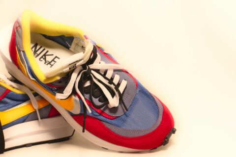 A pair of sneakers with a shoelace on top of them