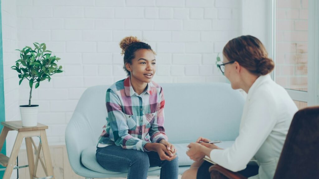 Two women talking in a modern office setting