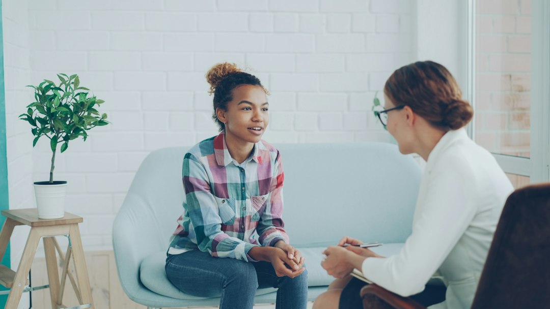 Two women talking in a modern office setting